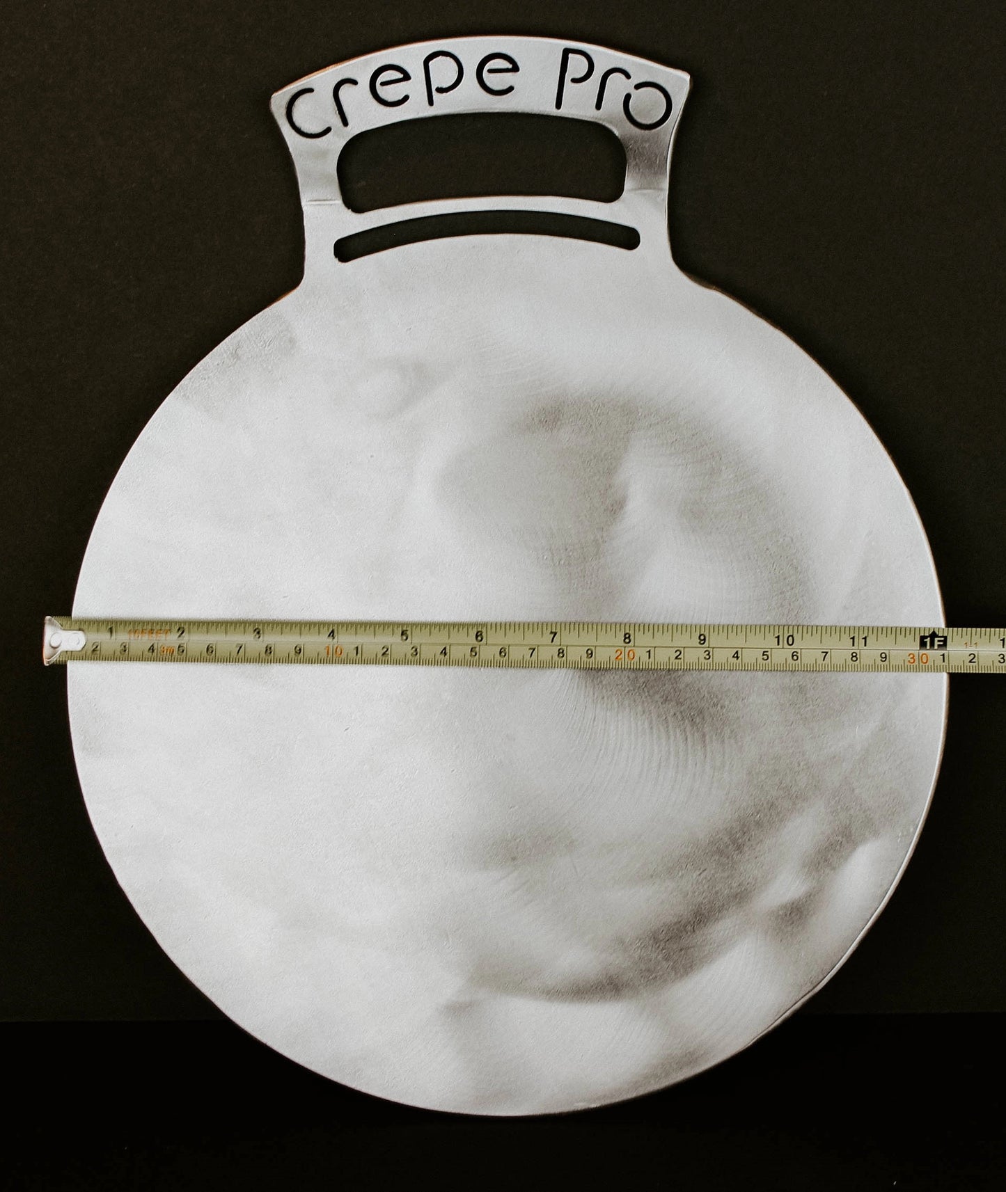 Carbon steel pan crepe pan cooking crepes on stovetop